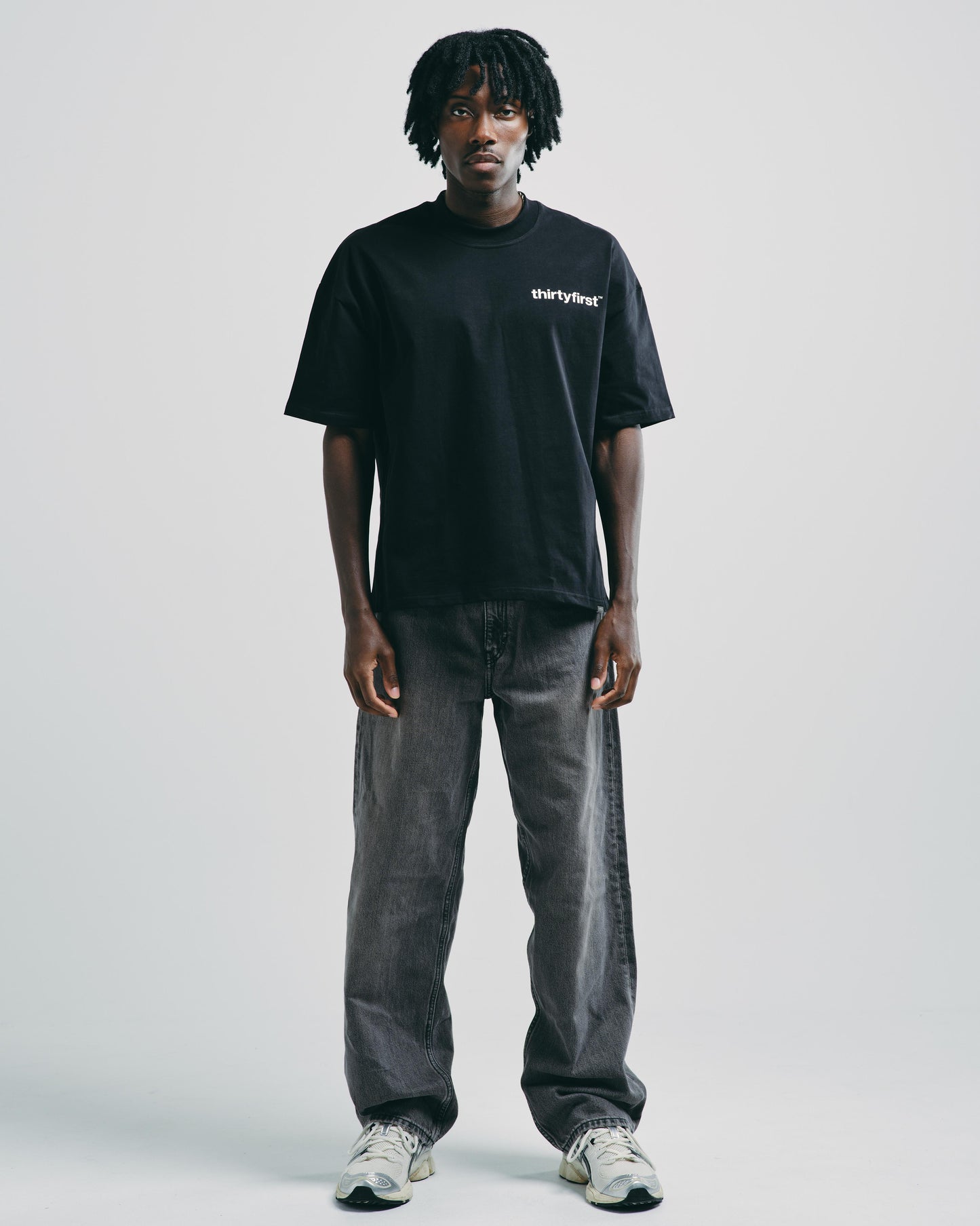 Model styled in black heavyweight graphic tee, perfect for a casual or sporty everyday look.