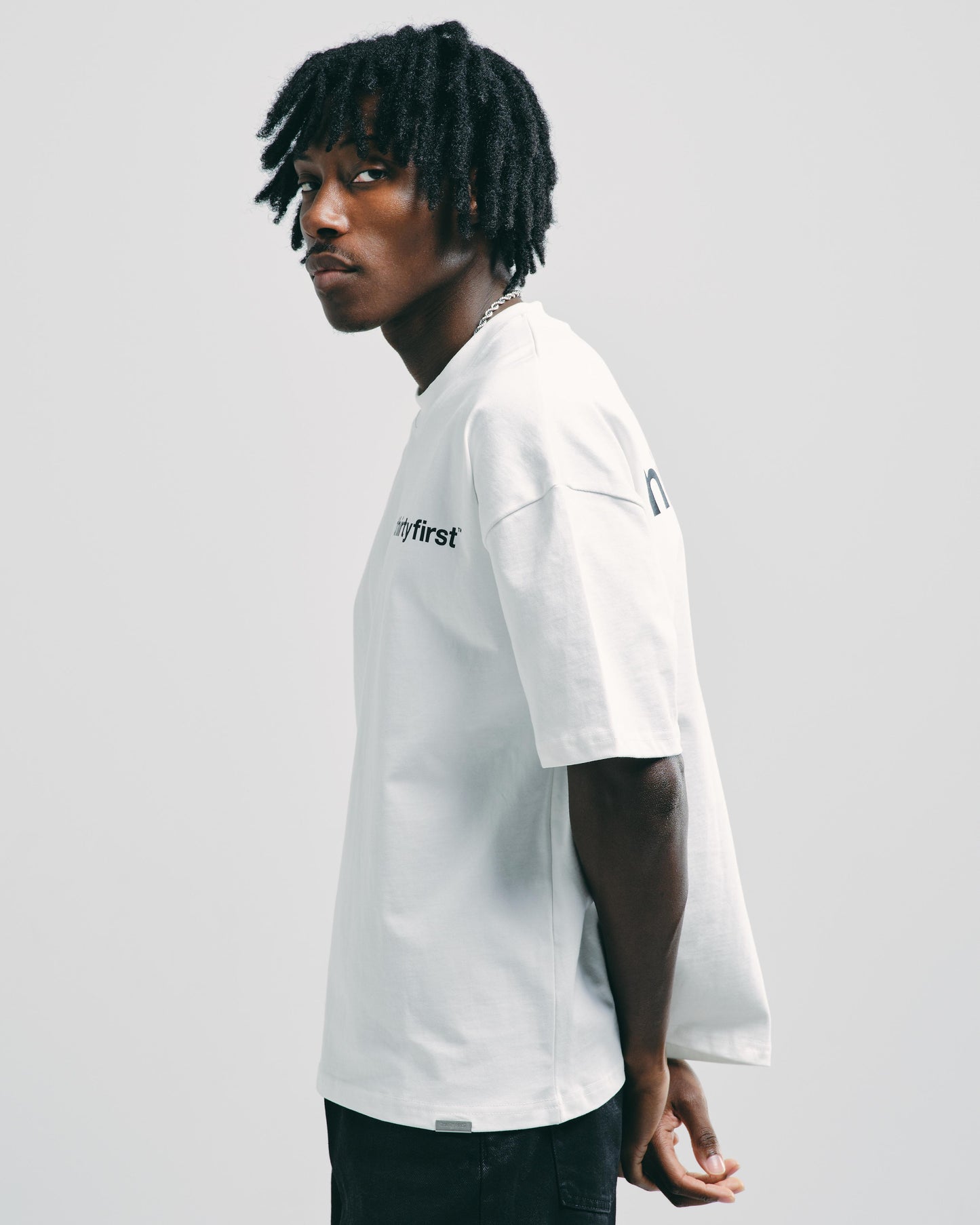 Men’s white heavyweight graphic t-shirt, showing relaxed cut fit.