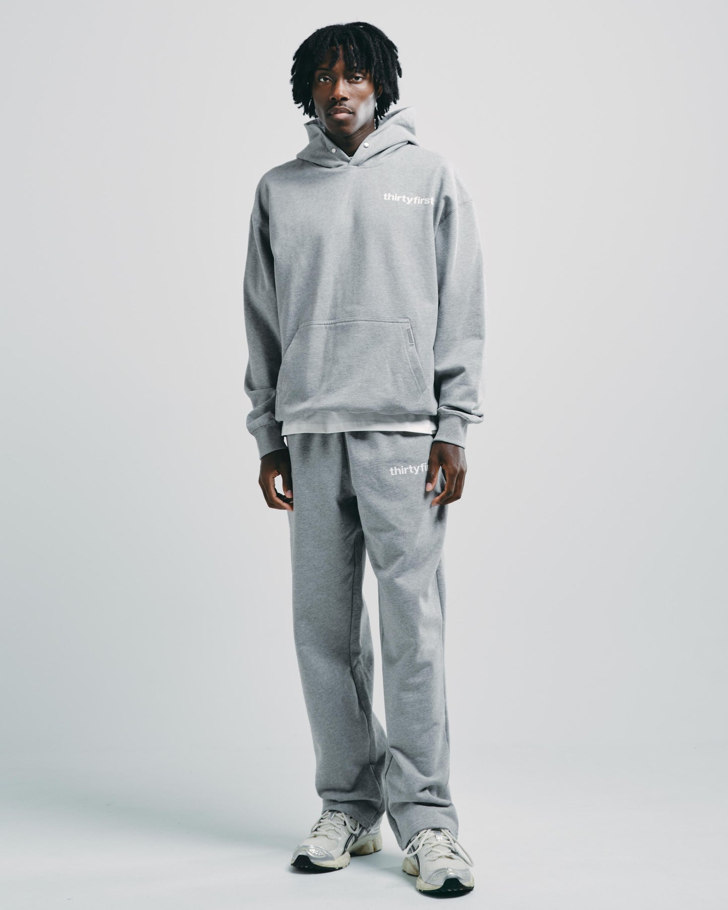 Man wearing light grey marl heavyweight hoodie, styled casually for everyday wear.