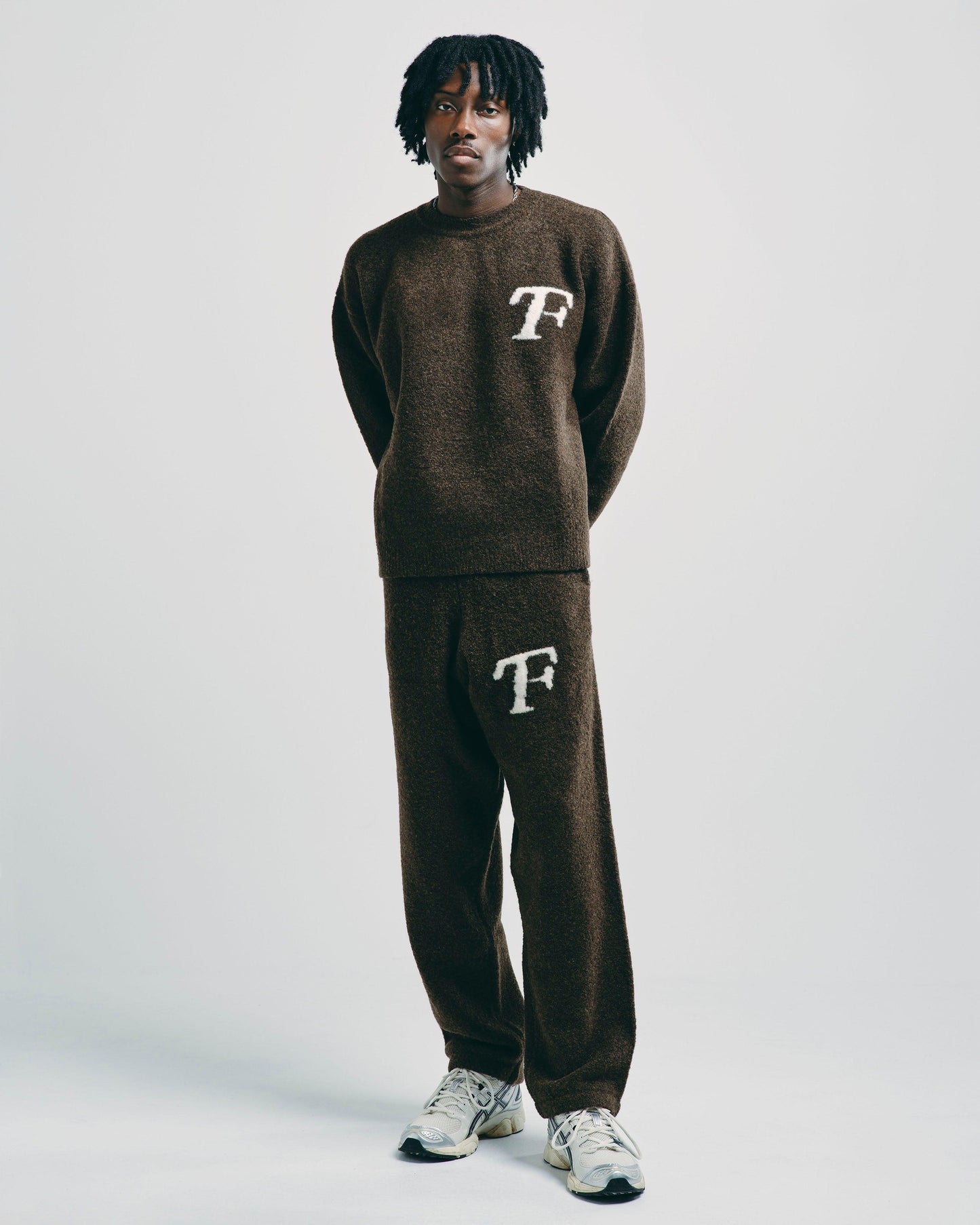 Model wearing mocha brown knitted sweater, styled casually for a modern, relaxed look.