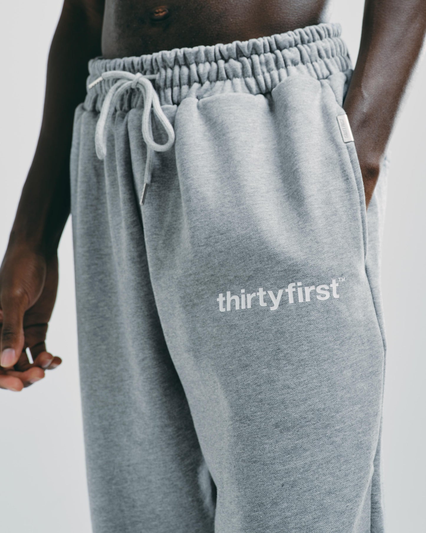 Close-up of men’s grey cotton tracksuit bottoms, highlighting the breathable cotton fabric and drawstring detail.